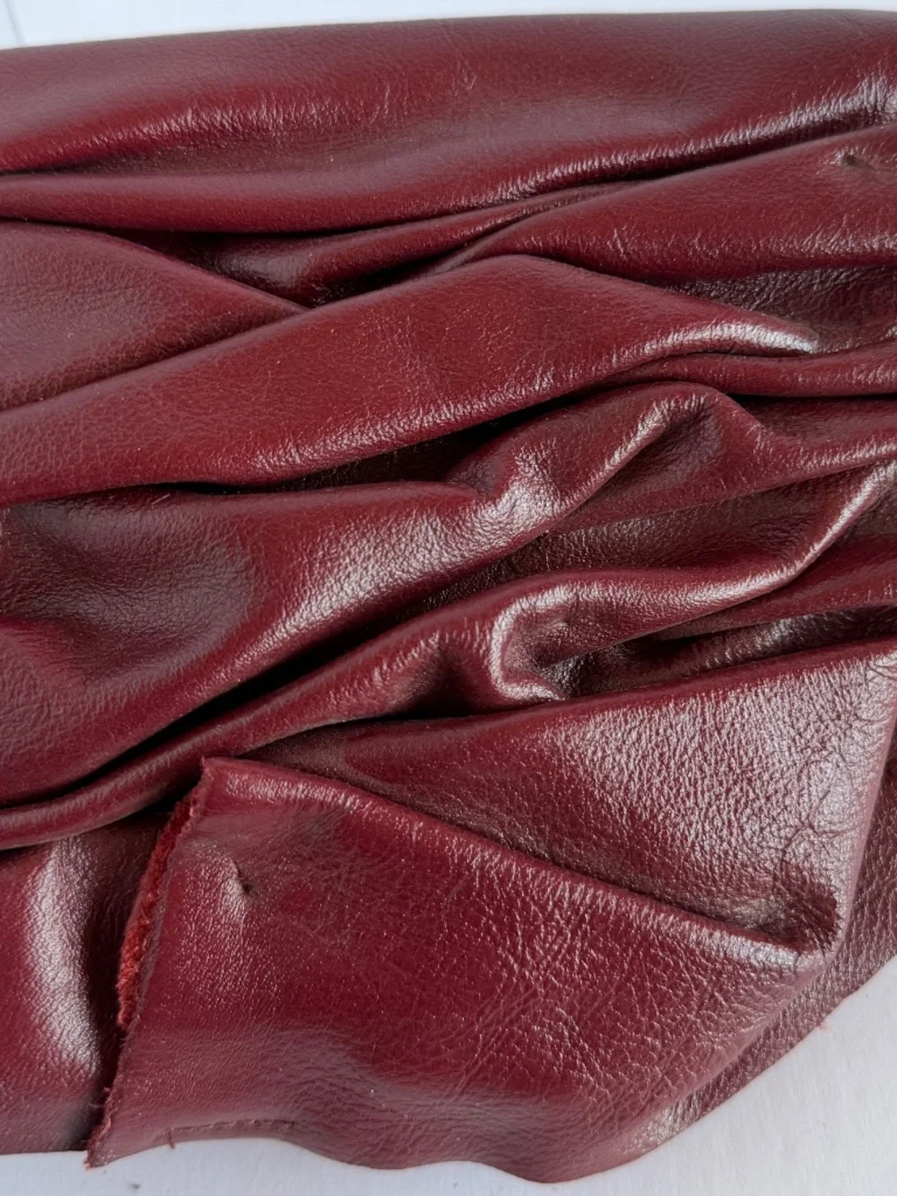Burgundy Pleated Leather Handbag Featuring a Soft Ruched Design